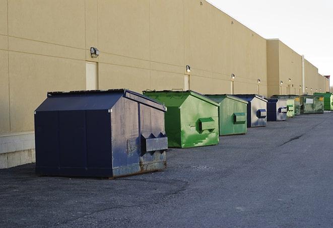 a row of construction dumpsters parked on a jobsite in Eagleville